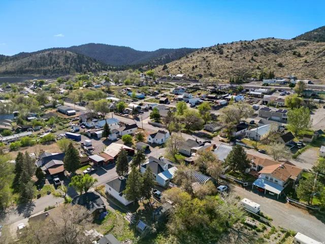 Expansive aerial perspective showcasing a residential community nestled within a mountainous landscape