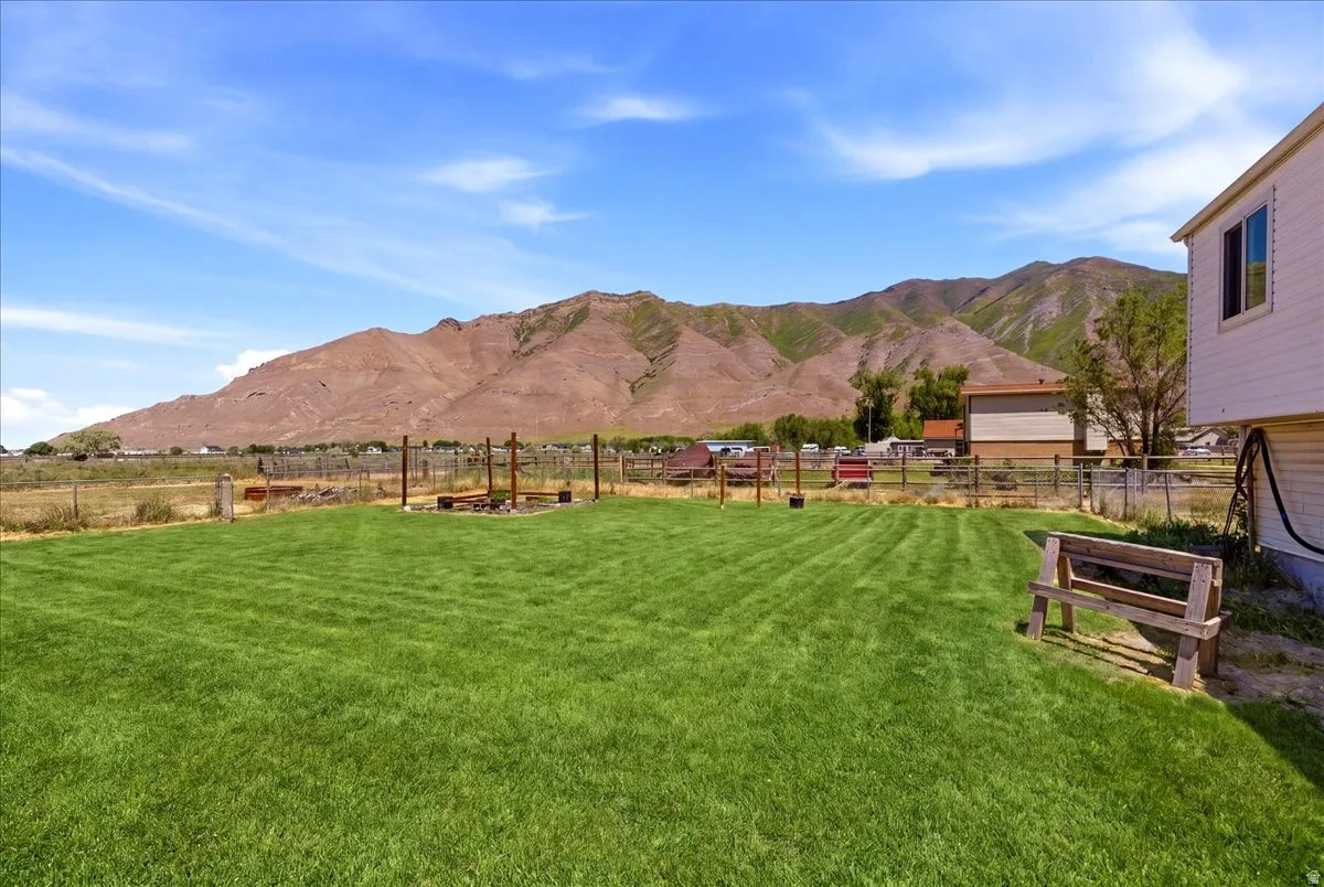 Expansive green lawn with mountain backdrop