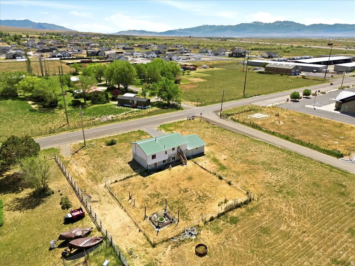Property featuring a two-story structure with a green metal roof and white siding