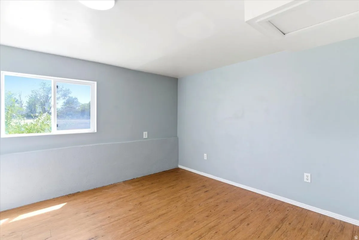 Light blue painted walls with white trim and wood-finish flooring