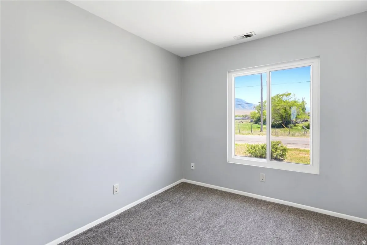 Bright interior space featuring a large window with a scenic outdoor setting