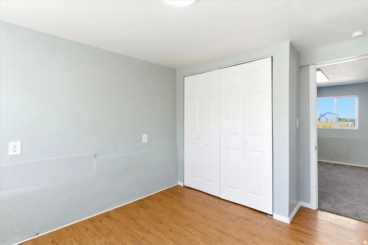 Interior room with wood-finish flooring and light gray painted walls