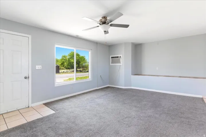 Spacious interior with neutral gray walls and gray carpet flooring