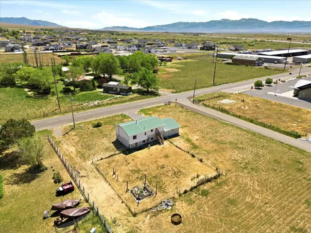 Property featuring a two-story structure with a green metal roof and white siding