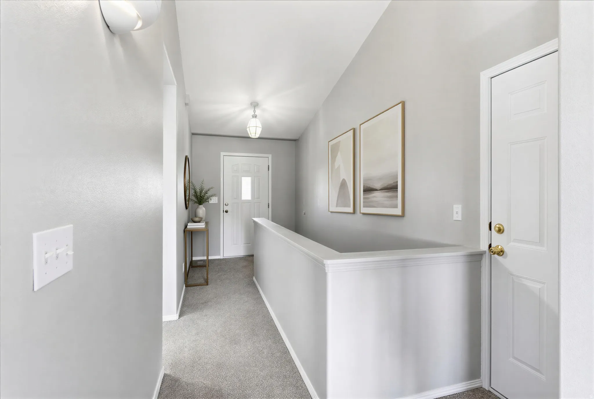 Entryway featuring light gray walls, plush gray carpeting, white trim, and a white paneled door with a rectangular glass insert