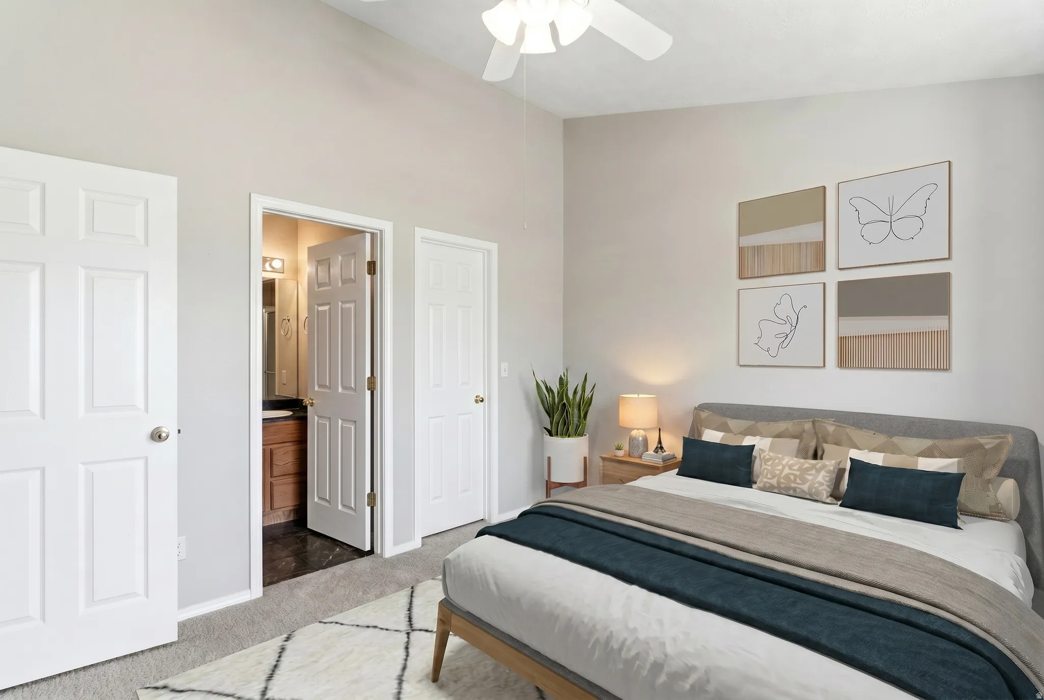 Carpeted bedroom featuring a vaulted ceiling and a ceiling fan