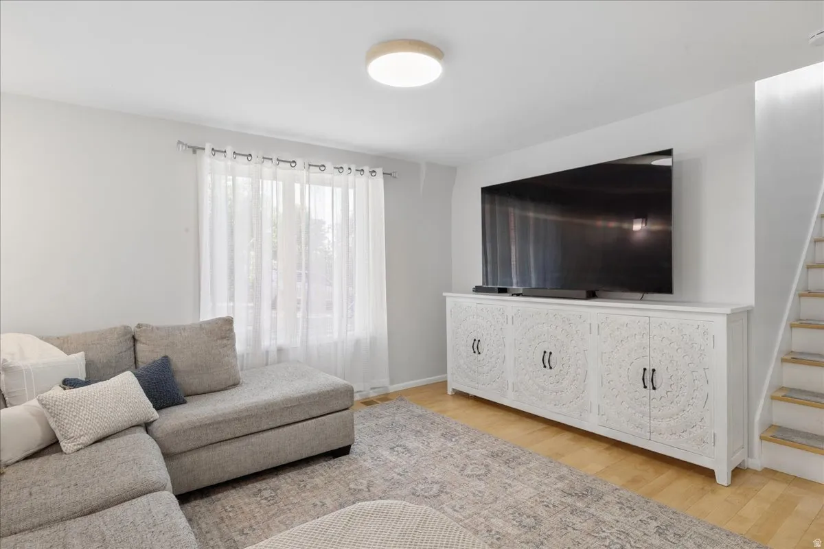 Living area featuring light wood-finish flooring and neutral wall tones