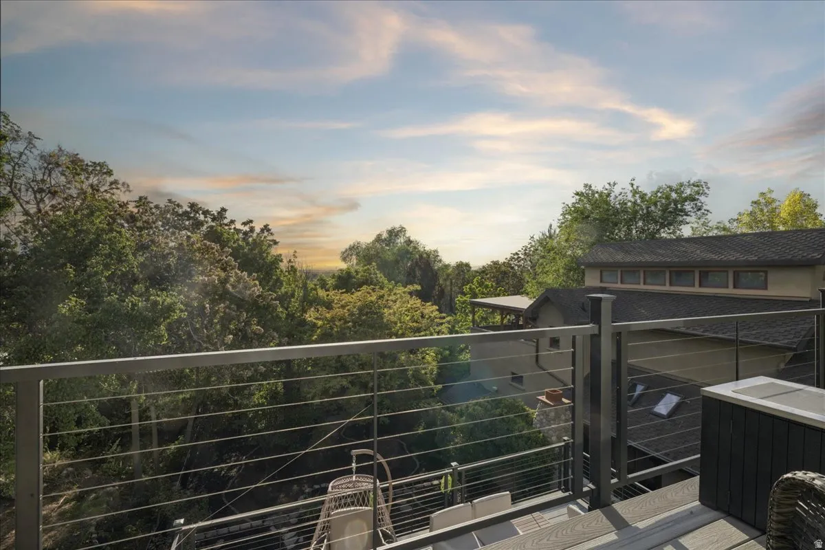 Expansive outdoor deck featuring composite wood-finish decking and a modern cable railing system