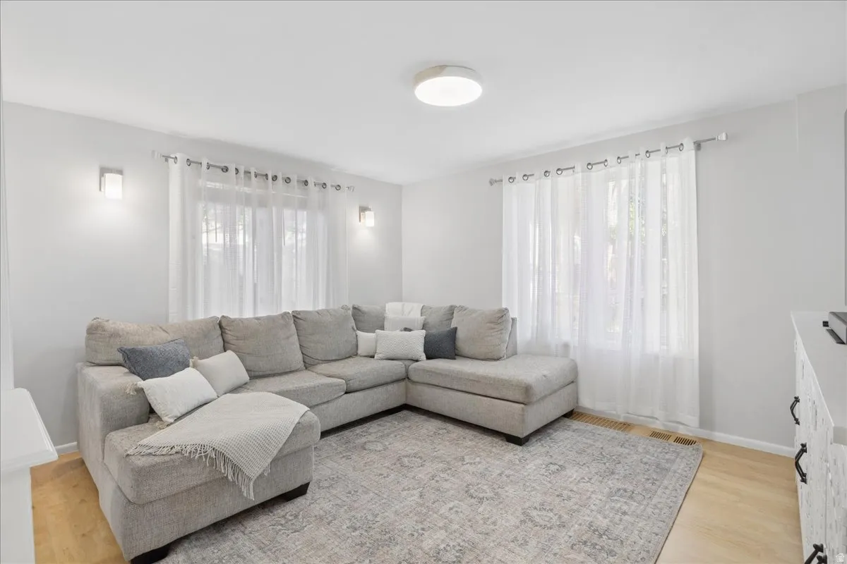 Recessed lighting, wood-finish flooring, and white walls