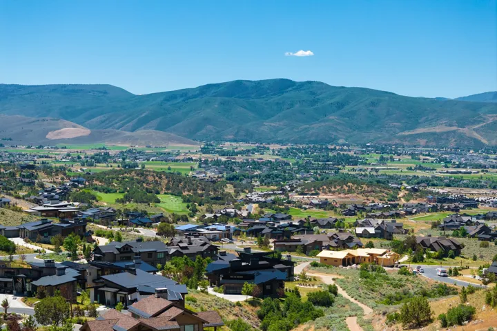Expansive mountain and valley scenery with residential development