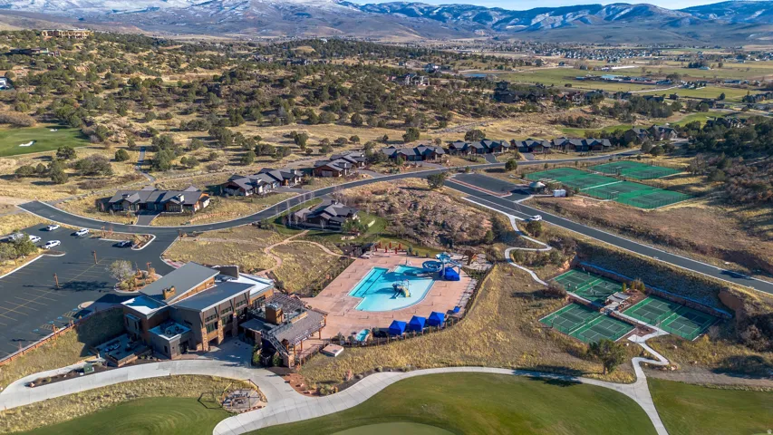 Expansive community with a clubhouse, outdoor pool, multiple tennis courts, and golf course access