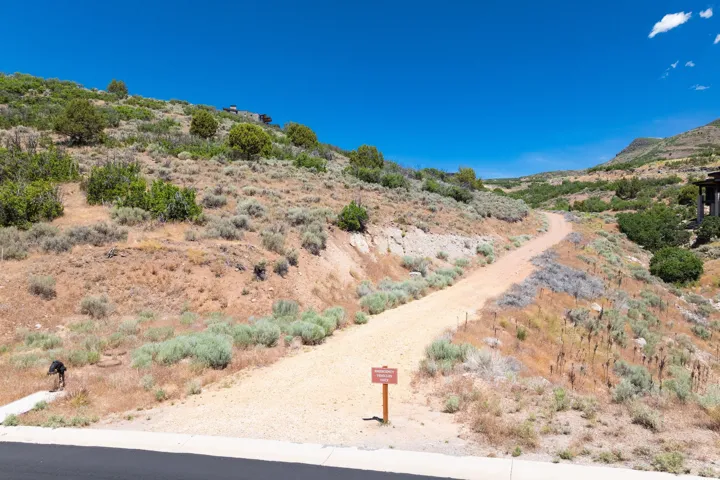 Gravel pathway ascending a natural, arid hillside