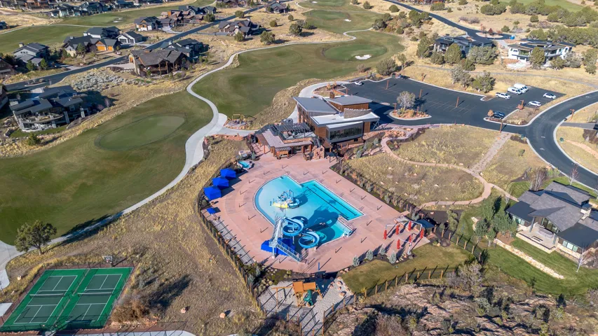Community amenities featuring a resort-style pool with waterslides, tennis courts, and golf course access