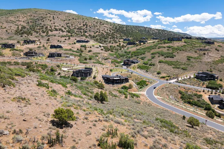 Hillside community featuring paved roads and multiple residences