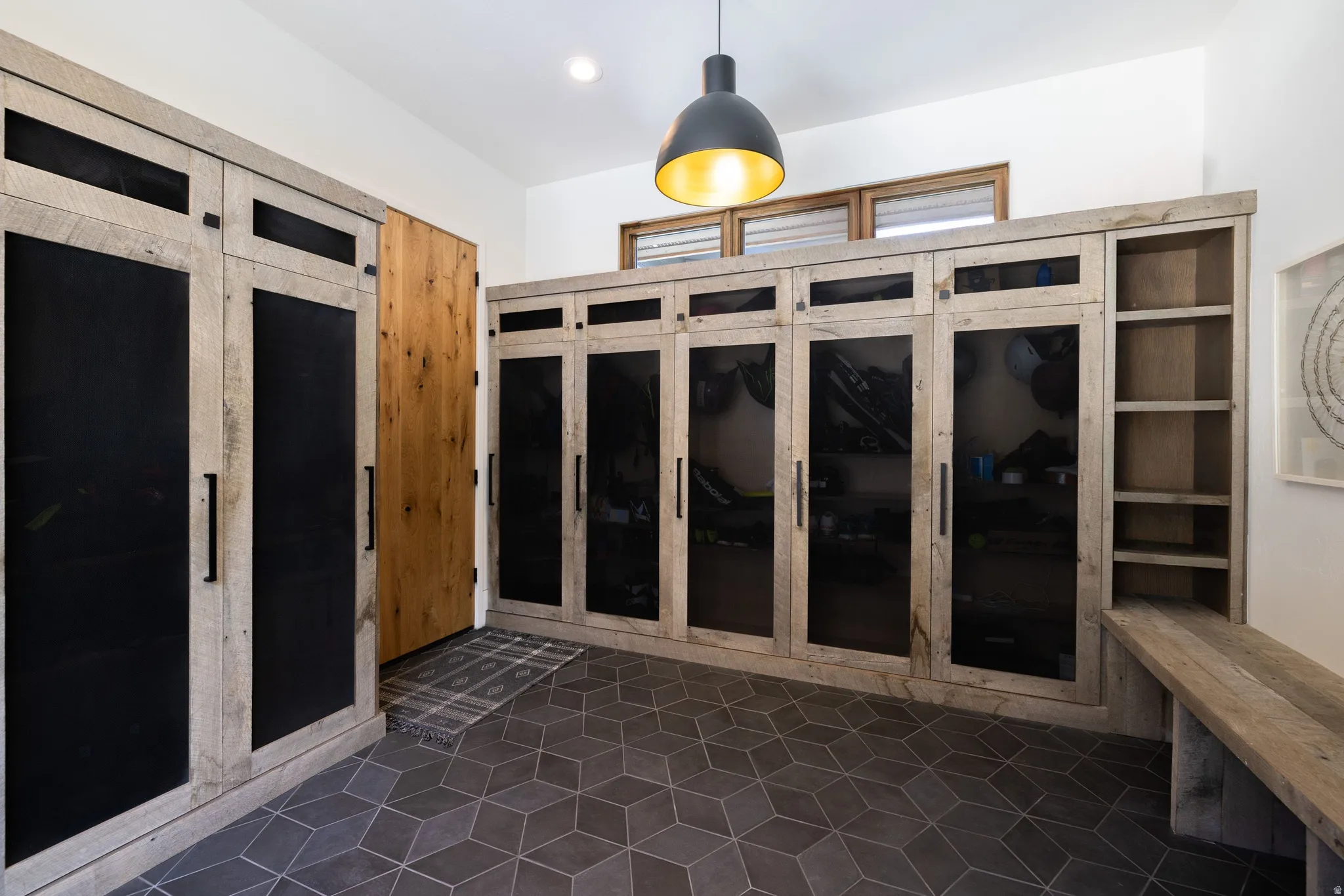 Built-in cabinetry with wood-finish framing and dark, opaque panels