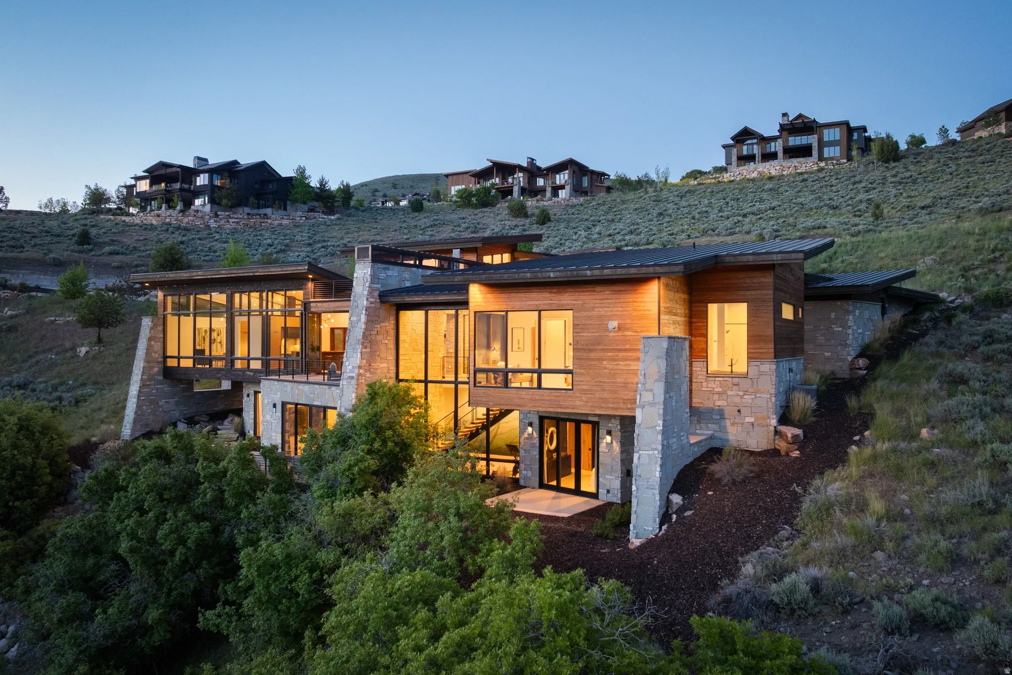 Multi-level contemporary residence featuring extensive use of natural wood siding and stone masonry