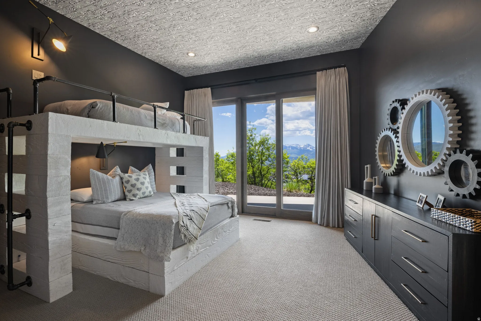 Spacious room featuring a built-in bunk bed structure with a ladder, recessed lighting, and dark wall finishes