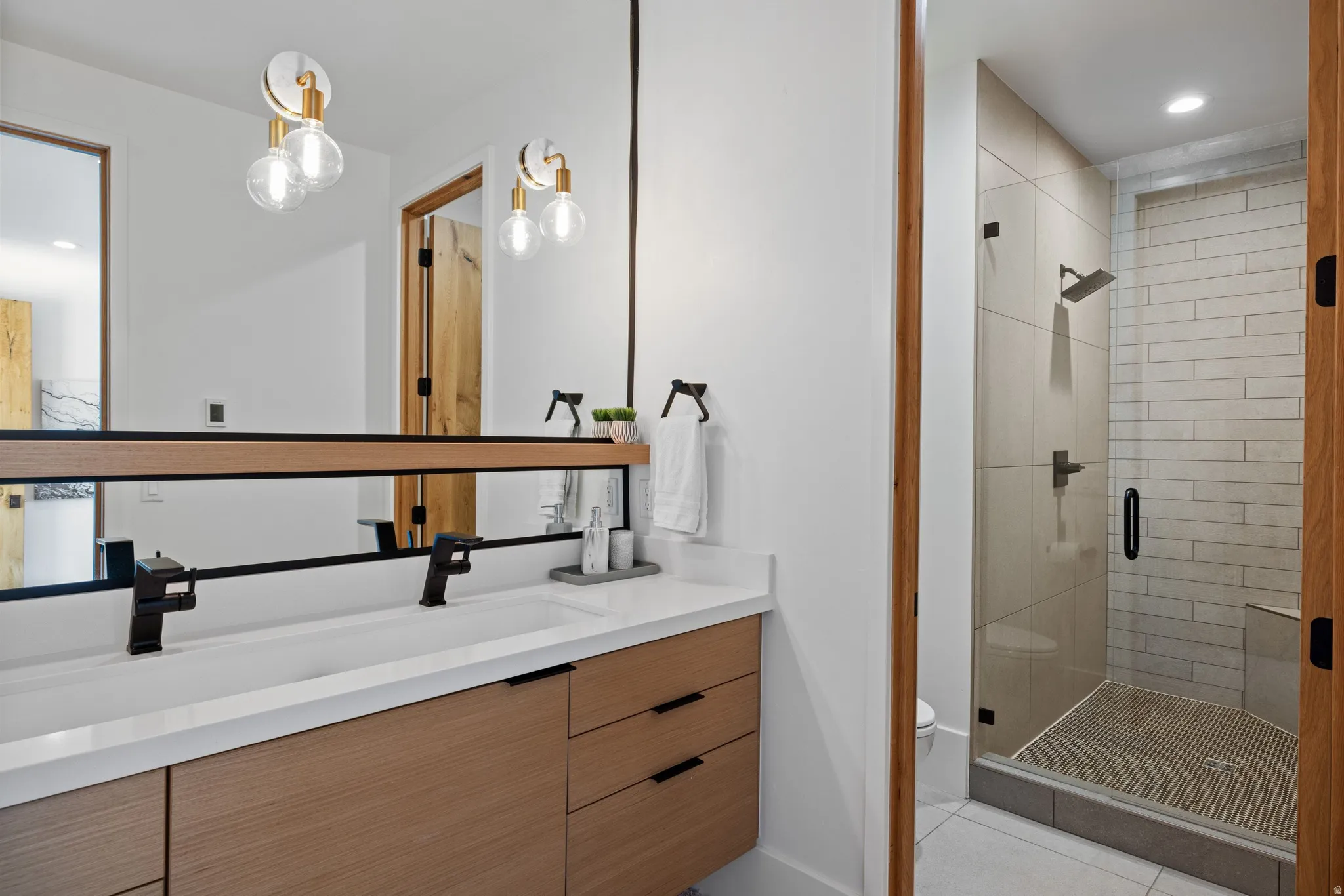 Dual vanity with integrated rectangular sinks, white countertop, and matte black fixtures