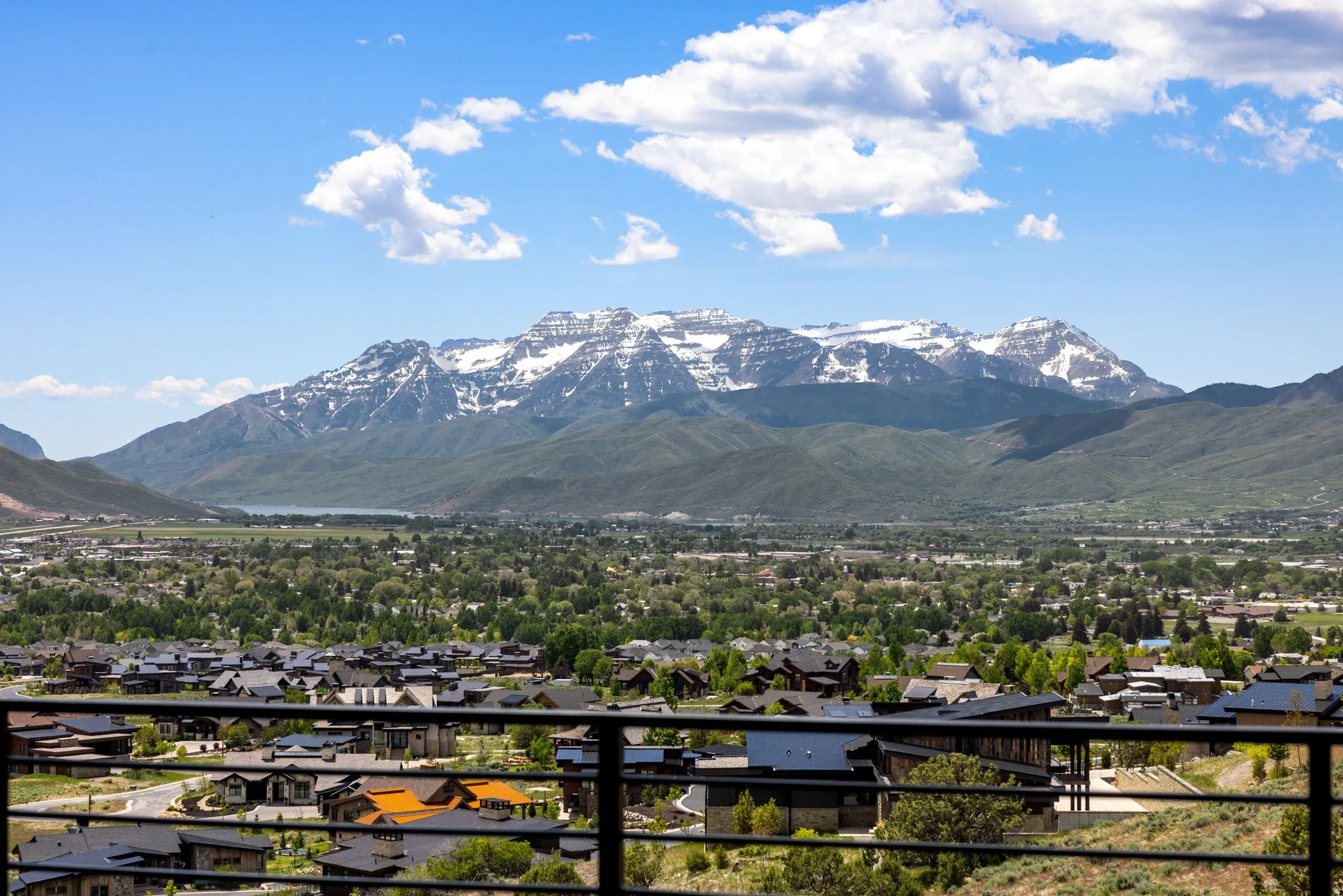 Expansive mountain scenery featuring snow-capped peaks and a valley landscape