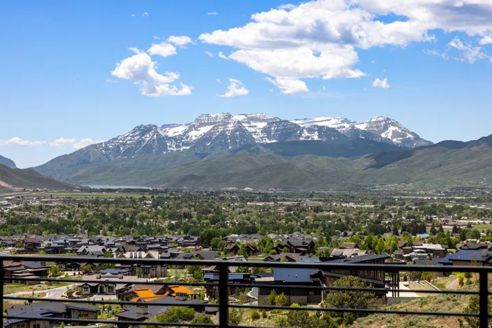 Expansive mountain scenery featuring snow-capped peaks and a valley landscape