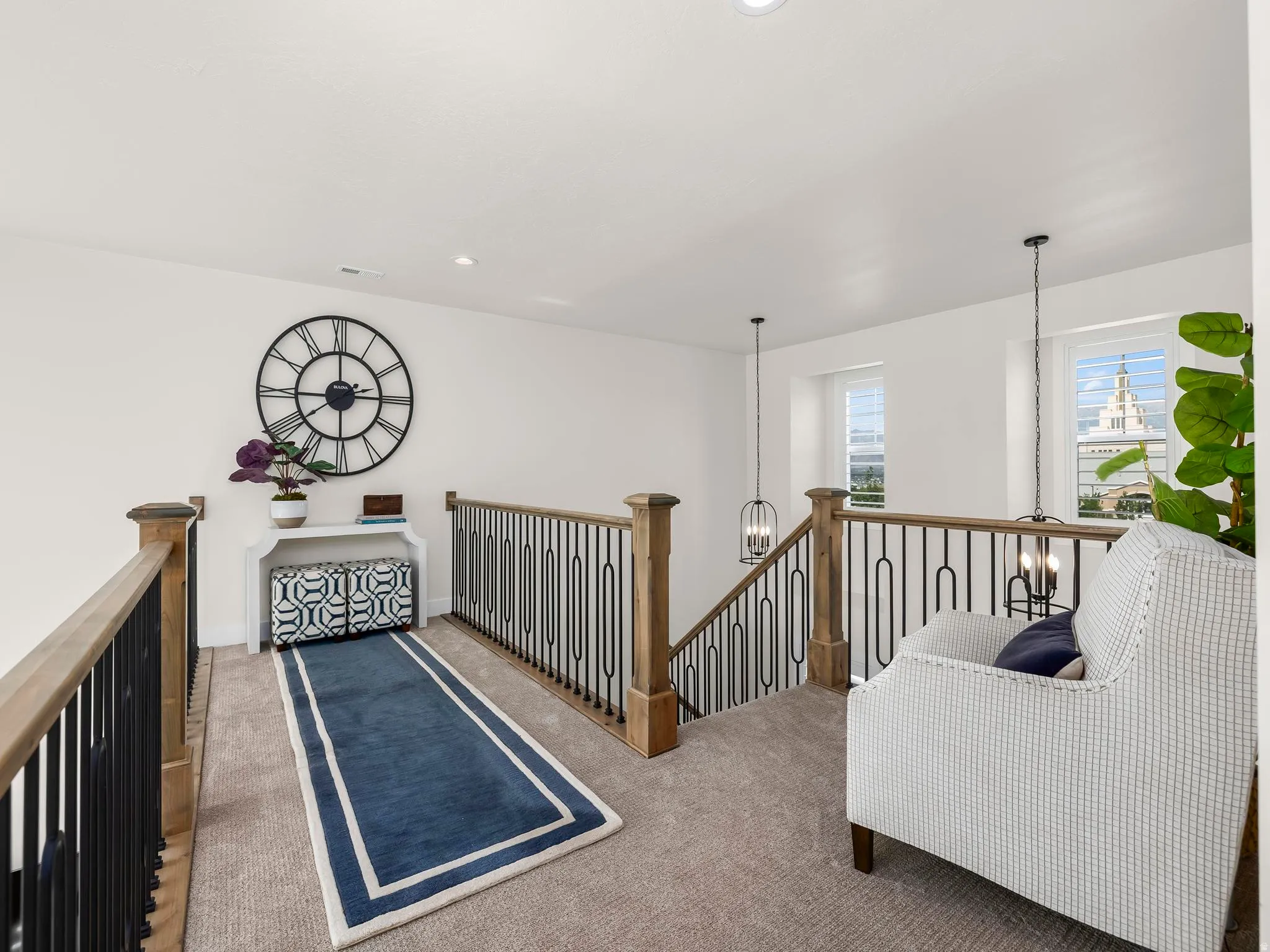 Open loft area featuring durable carpet flooring and white walls