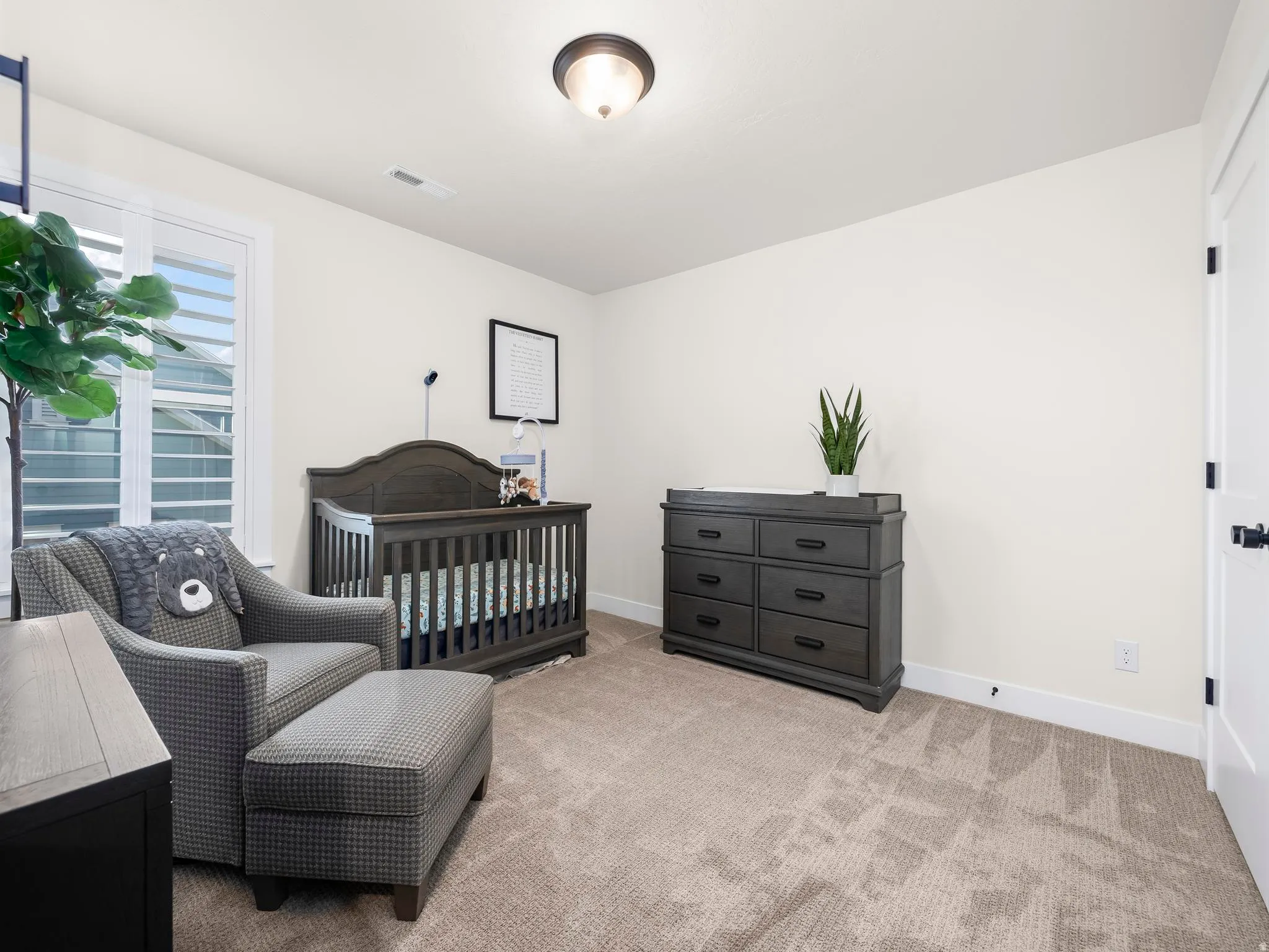 Interior room featuring light-colored walls and plush carpeting