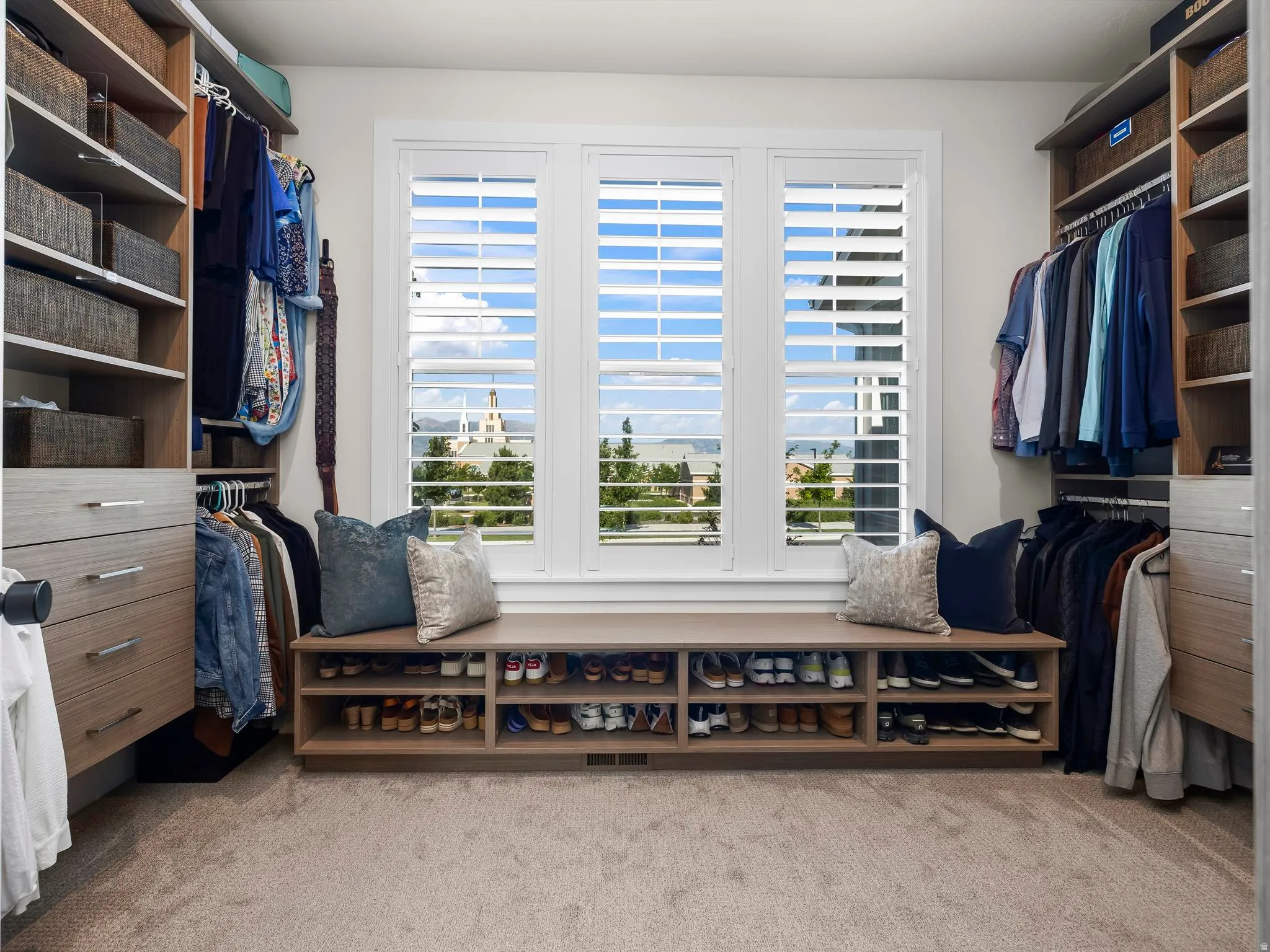 Custom closet system featuring extensive shelving, hanging rods, and built-in drawers