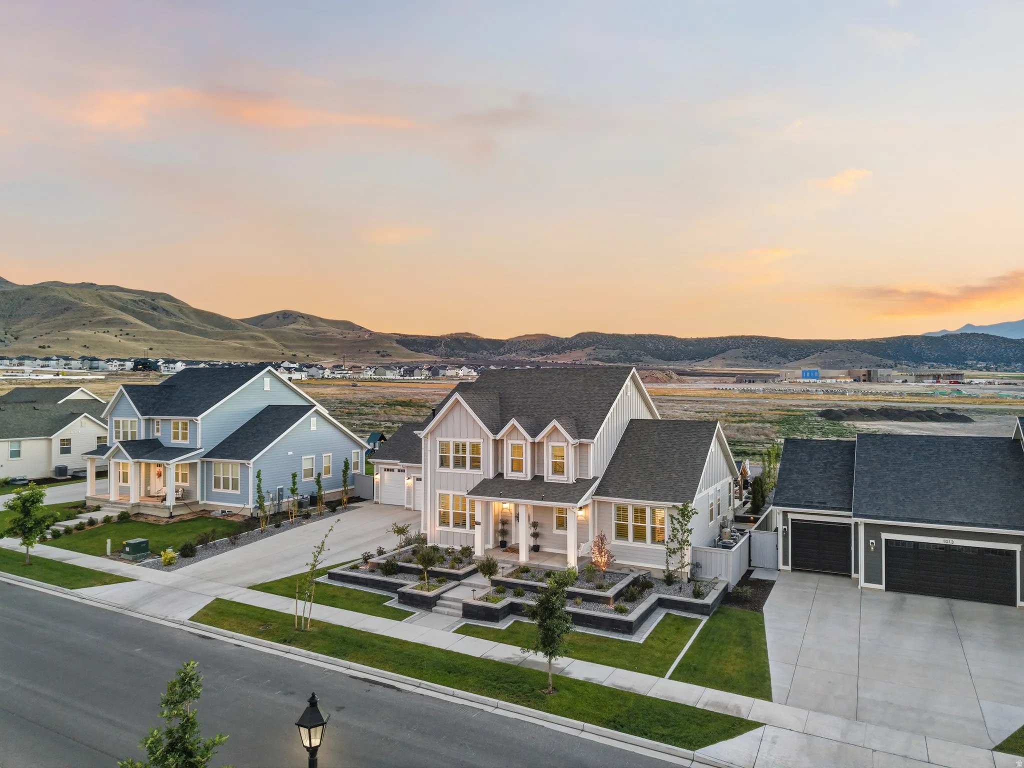 Crafted gray exterior with white trim and a covered front porch featuring columns