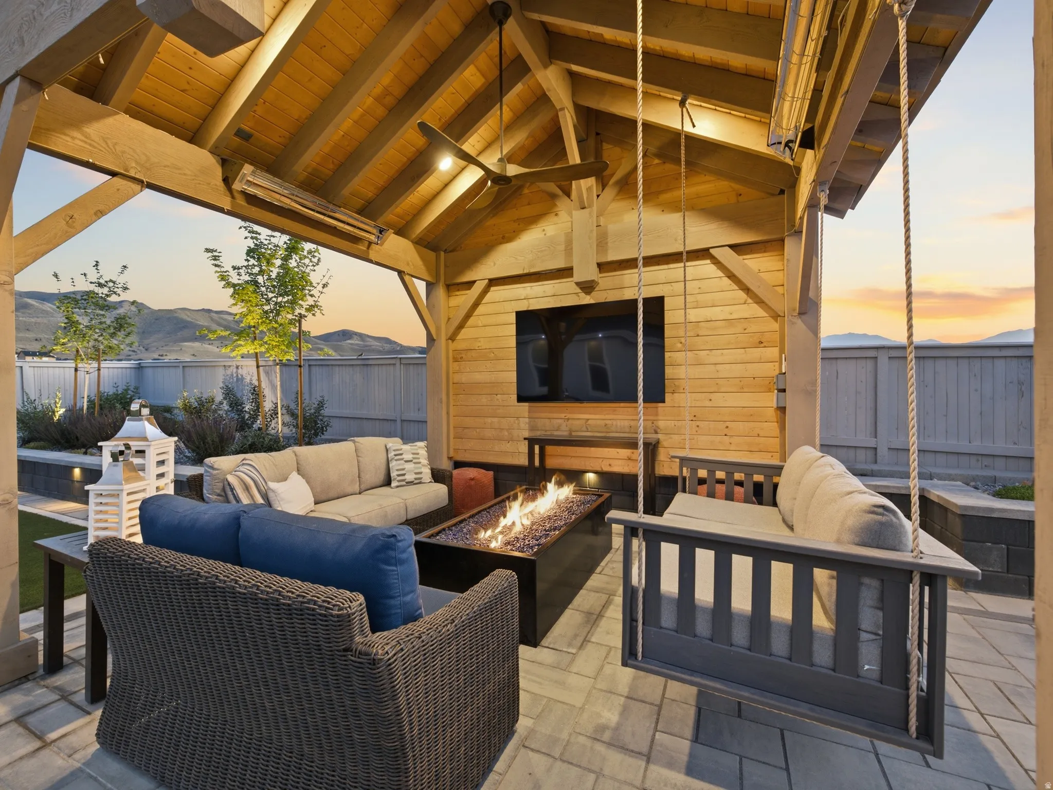 Covered outdoor living area featuring a wood-plank ceiling, exposed wood beams, and recessed lighting