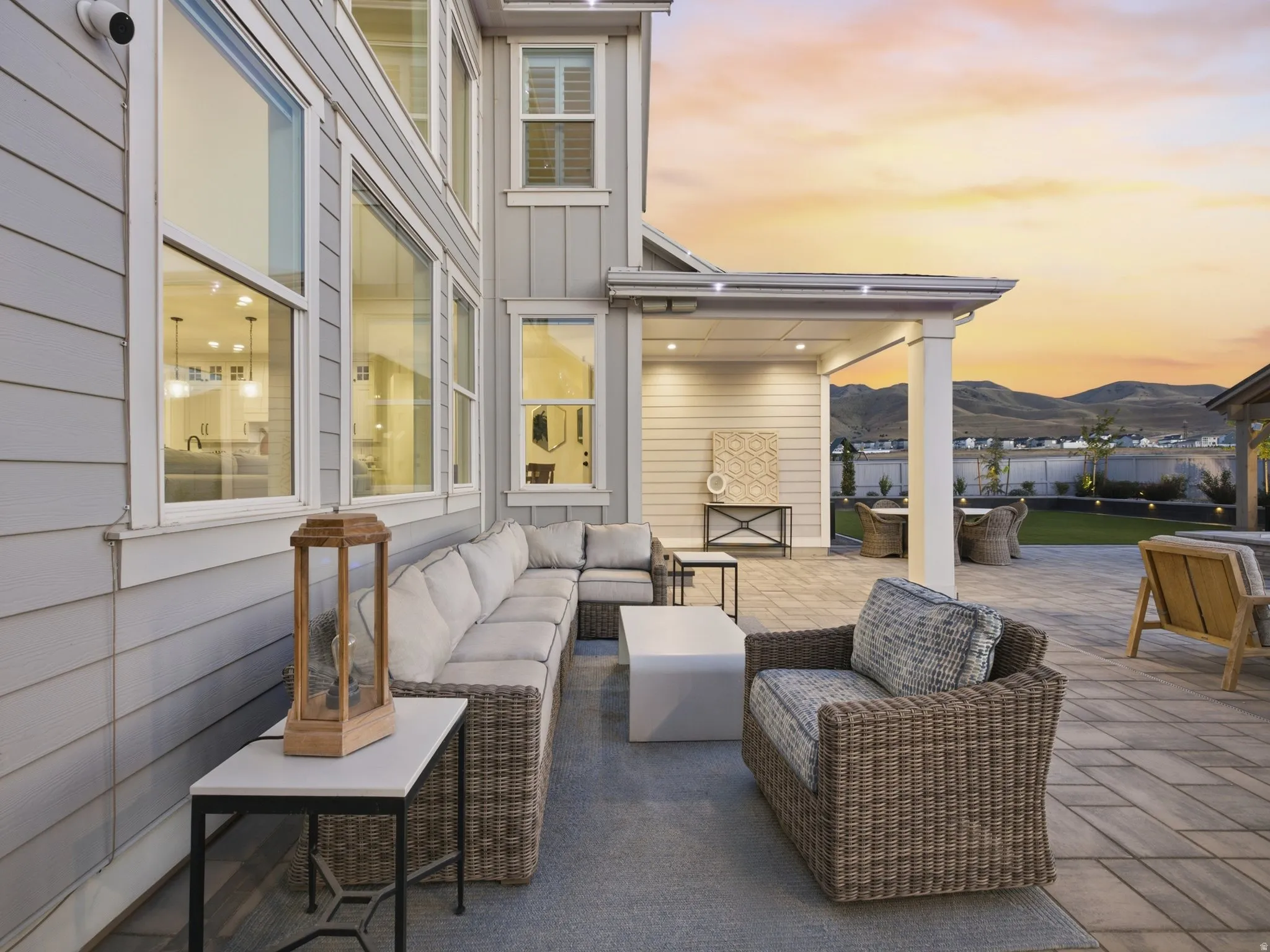 Expansive paver patio with a covered outdoor living area and recessed lighting