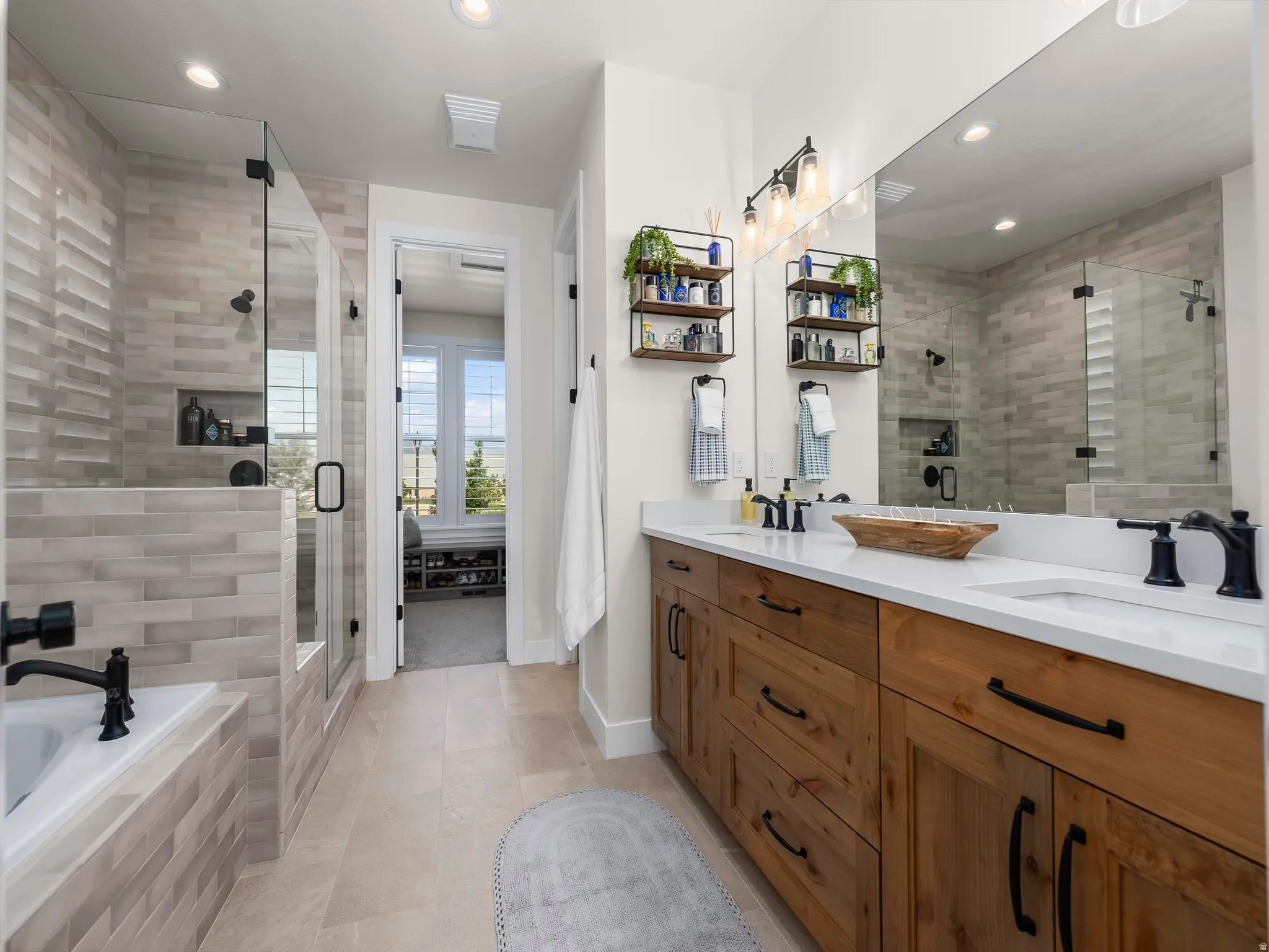 Dual sink vanity with wood-finish cabinetry, white countertops, and matte black fixtures