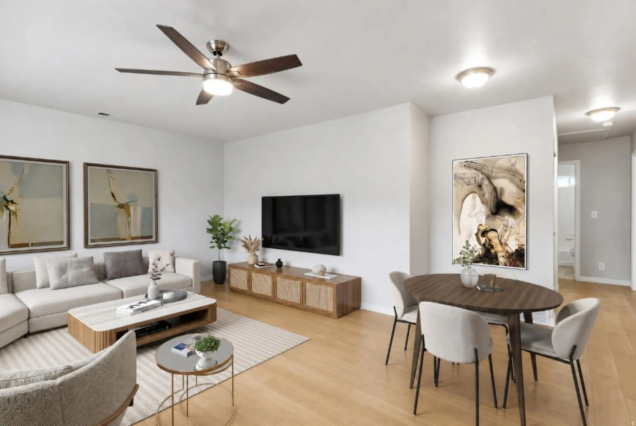 Open-concept living area with light wood-finish flooring, a contemporary ceiling fan, recessed lighting, and white wall finishes