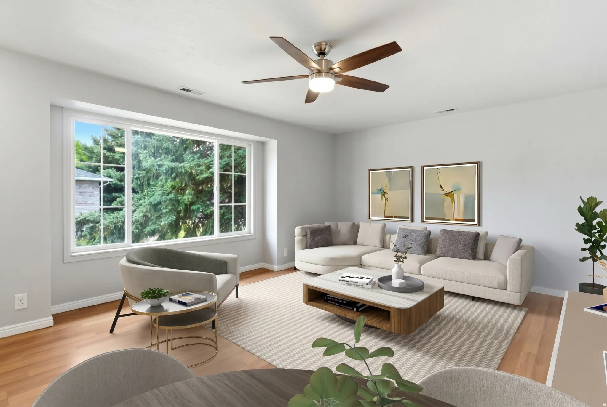 Spacious living area featuring a large picture window, wood-finish flooring, a ceiling fan with integrated lighting, and neutral wall tones