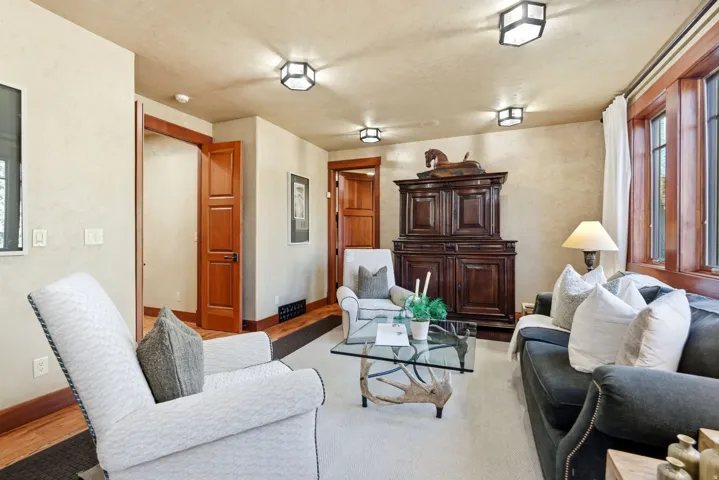 Living area with wood-finish trim and doors, textured wall finishes, and recessed ceiling lighting