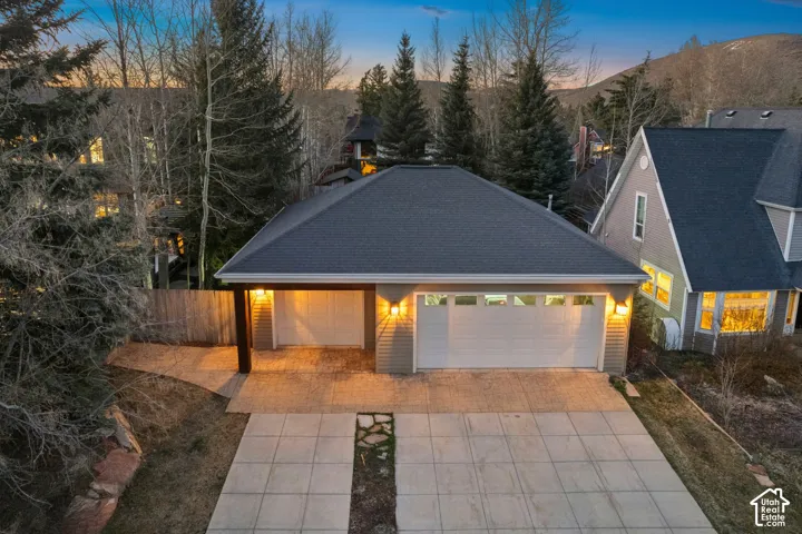 Siding exterior with a dark shingle roof and an integrated two-car garage