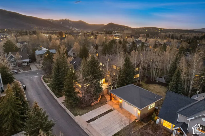 Aerial perspective showcasing a residential neighborhood with surrounding mountains