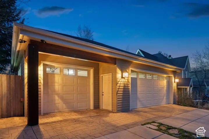 Two-car garage with panel-style doors and upper window inserts