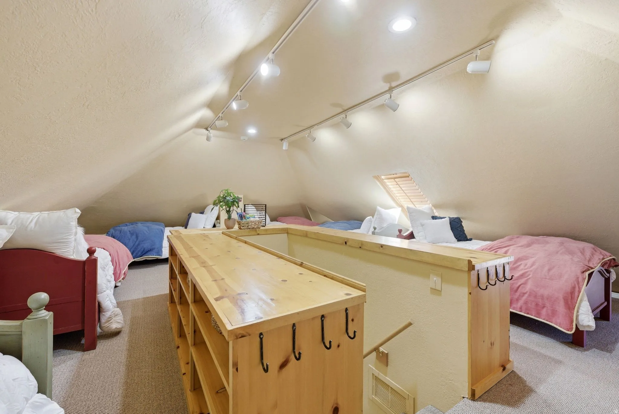 Spacious attic conversion with vaulted ceilings and recessed lighting