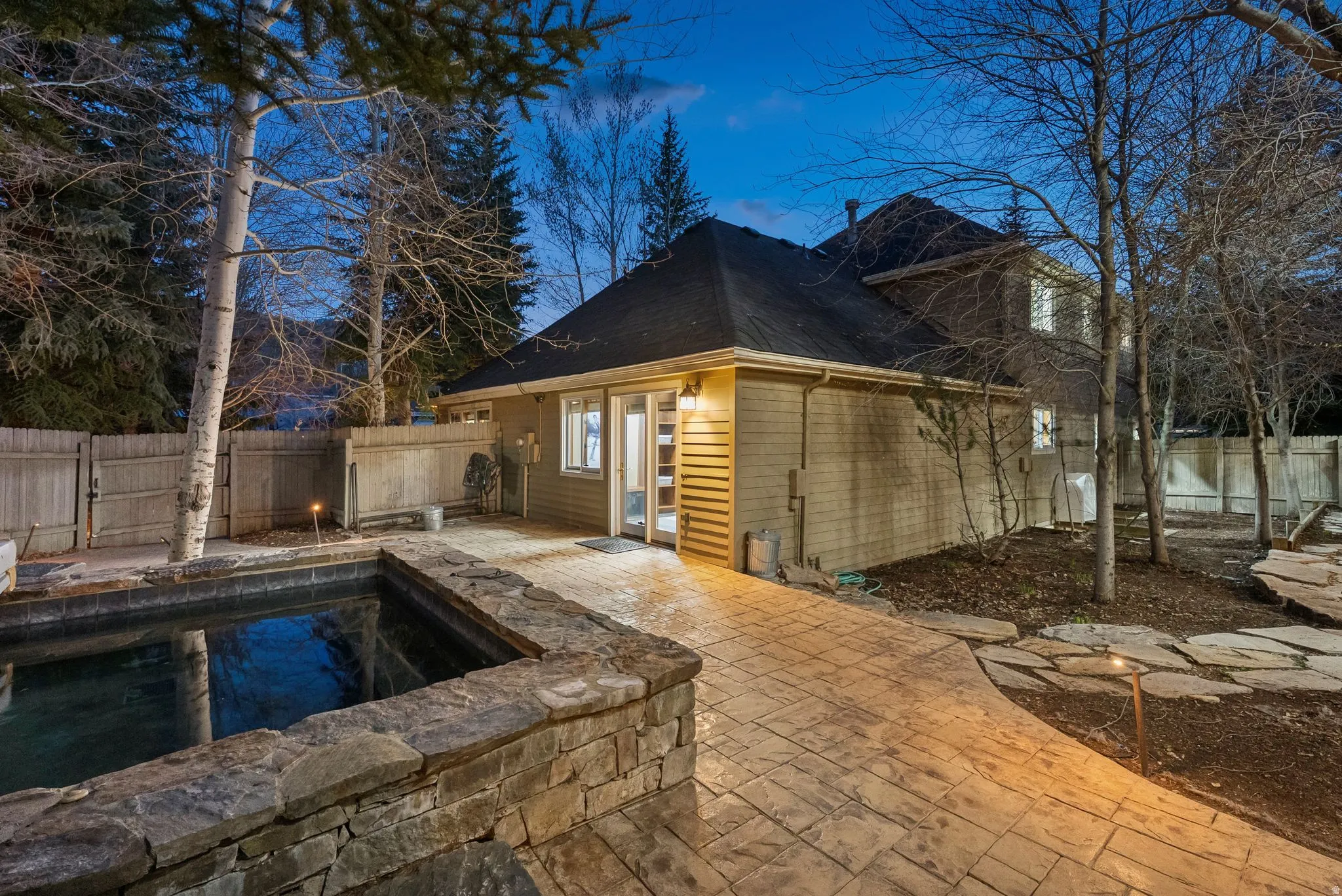 Exterior rear elevation featuring horizontal siding and a dark shingle roof