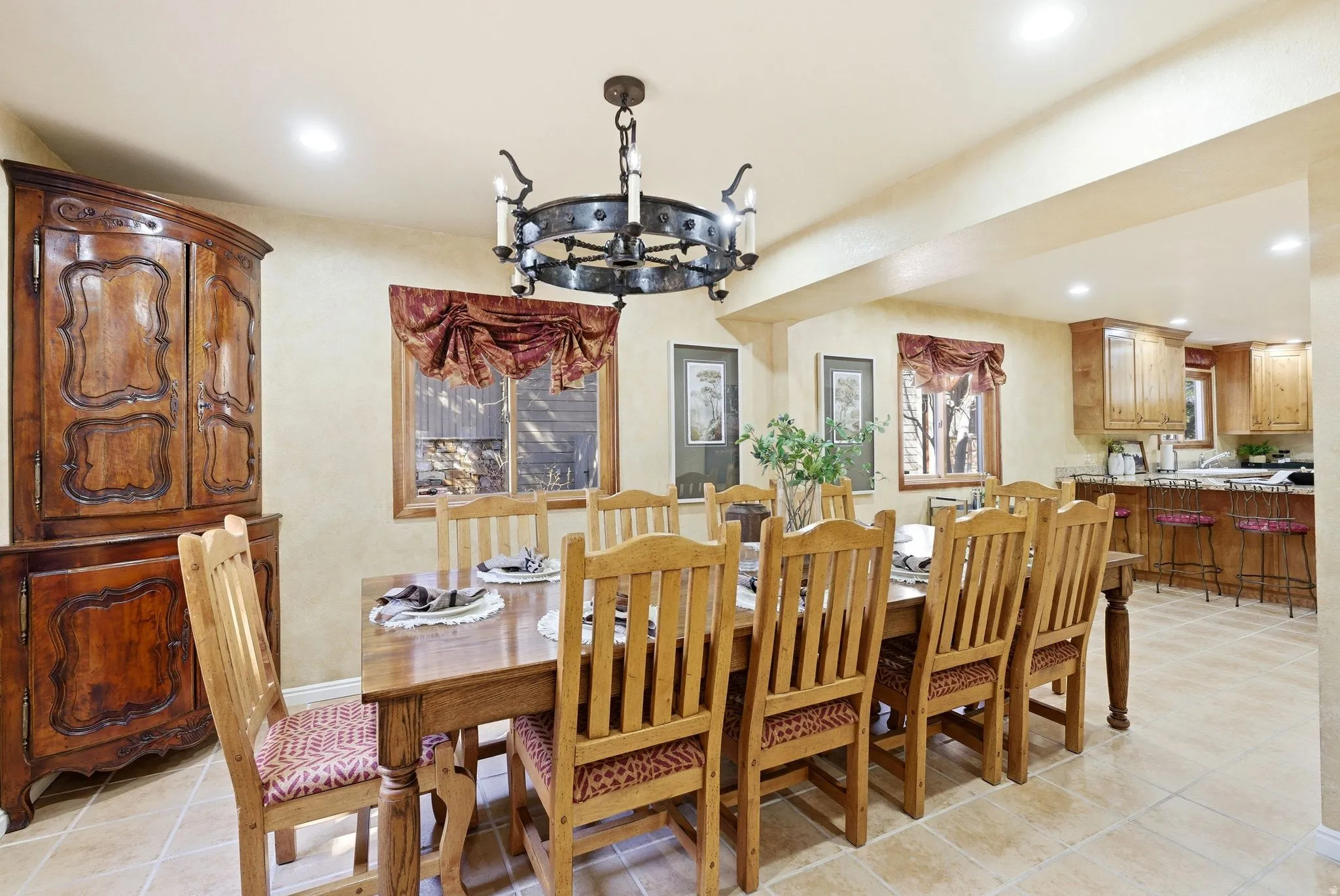 Dining area featuring a wrought iron chandelier and recessed lighting