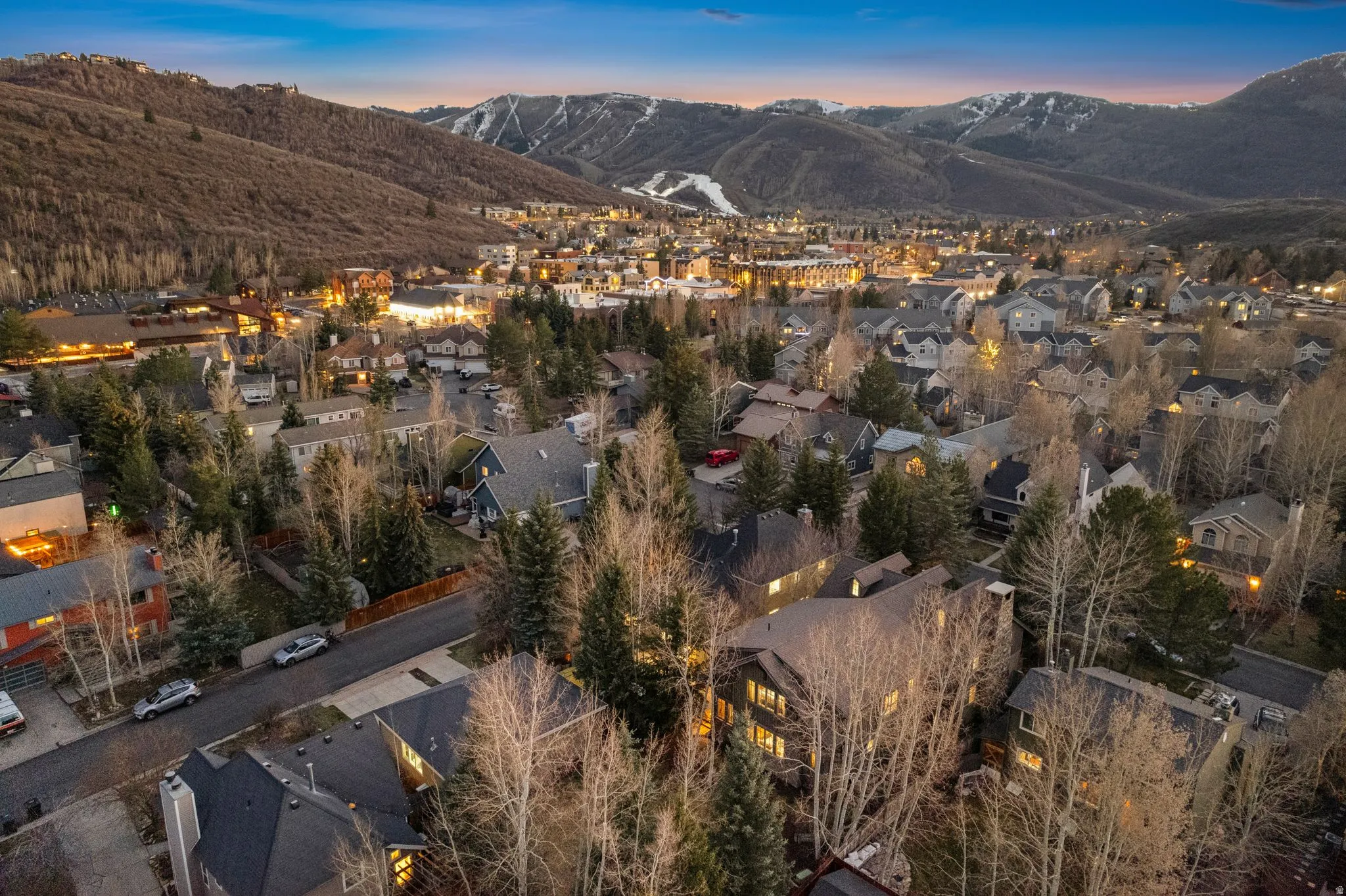 Aerial perspective showcasing a residential community nestled among forested hillsides