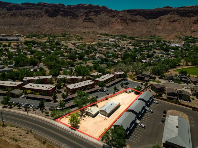 Expansive lot featuring a single structure with a metal roof, a secondary structure, and direct road frontage