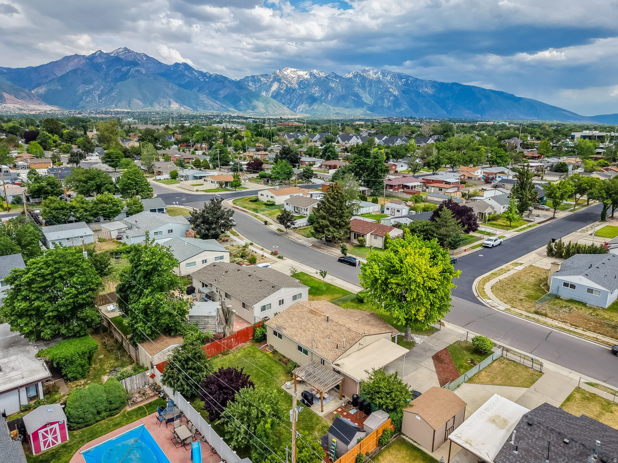 Expansive residential neighborhood with mature trees, established streets, and varied property styles