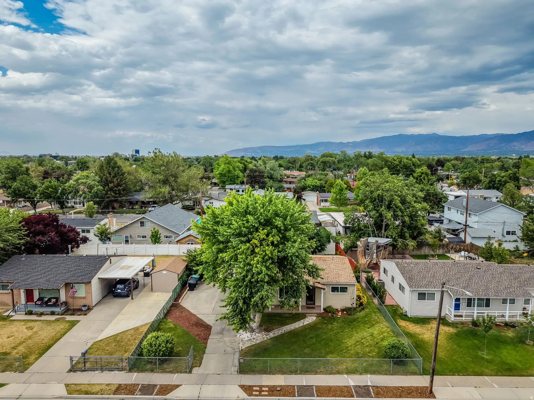 Aerial perspective showcasing a residential neighborhood with mountain backdrop