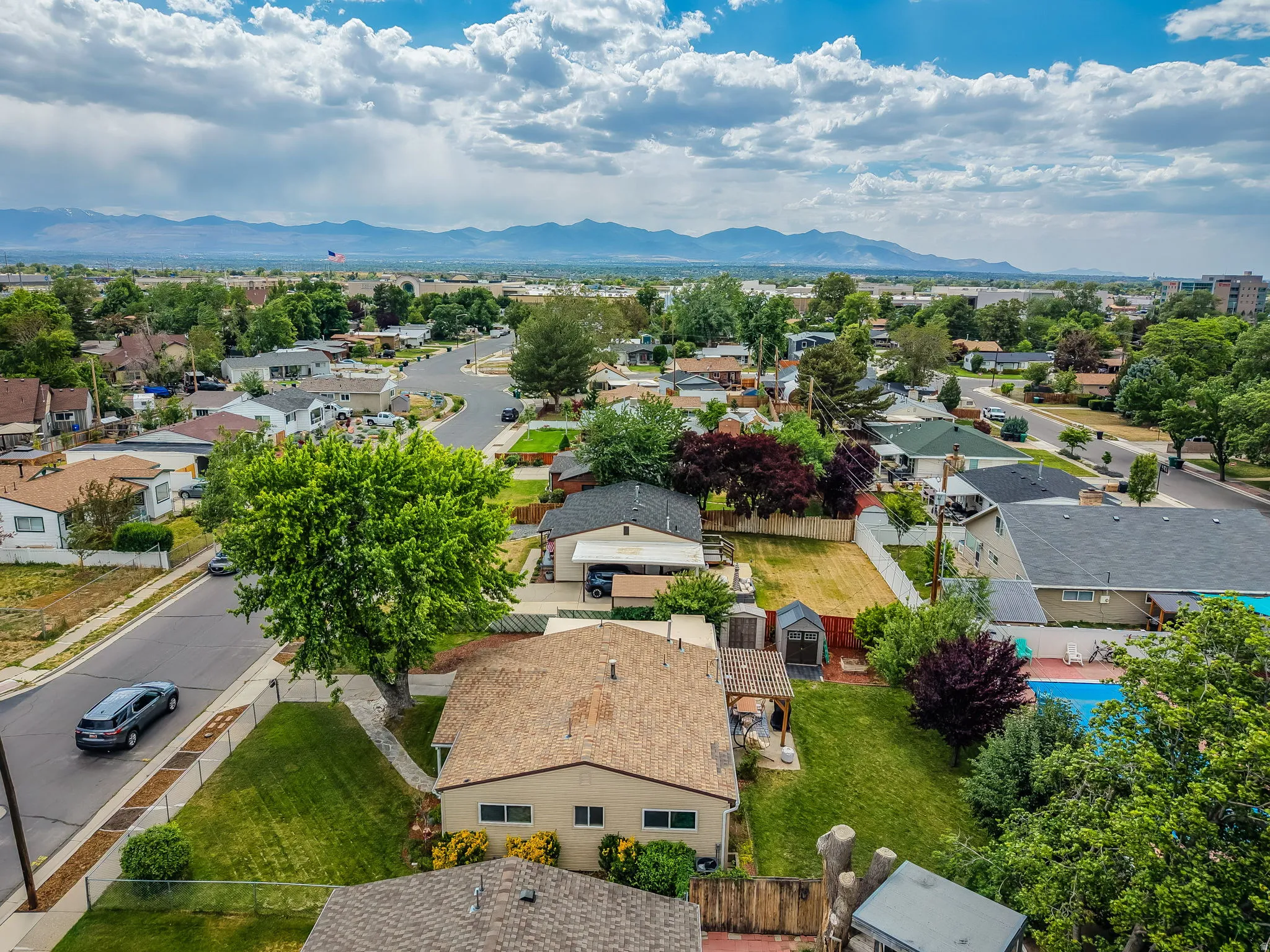 Aerial perspective showcasing a residential neighborhood with mountain scenery