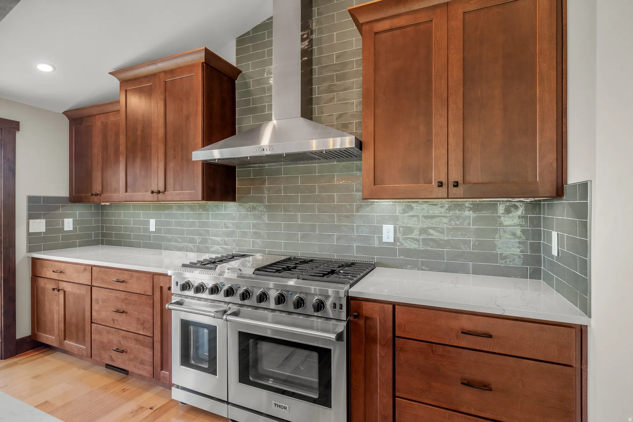 Stainless steel professional-grade range with a coordinating range hood