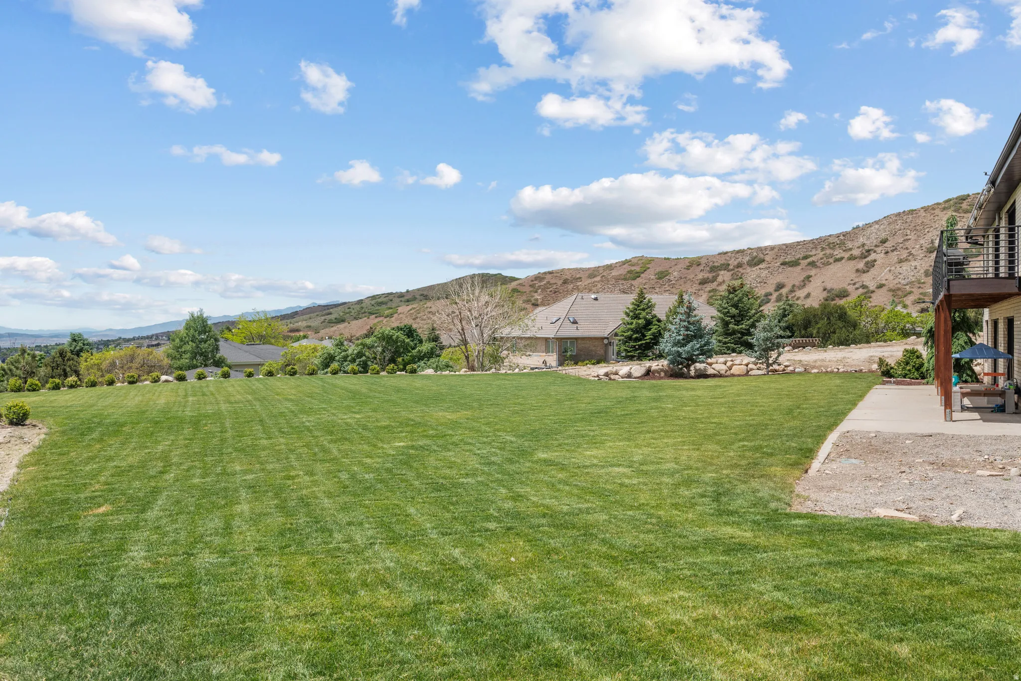 Expansive level lawn area with mountain scenery