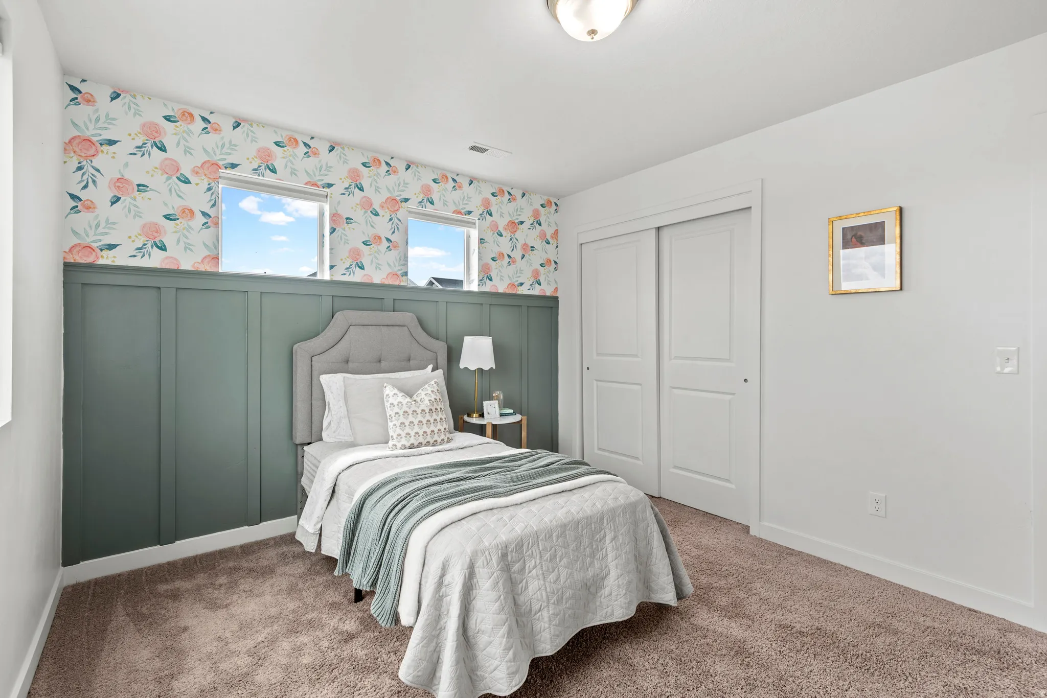 Room featuring decorative wainscoting and floral wallpaper
