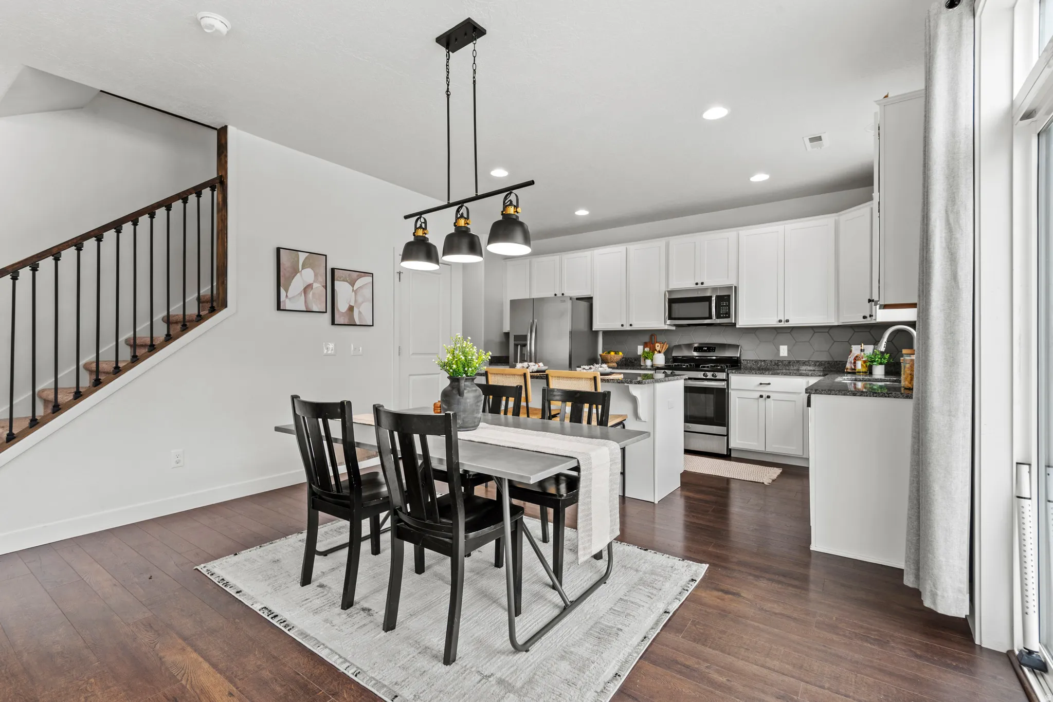 Open-concept living space with dark wood-finish flooring