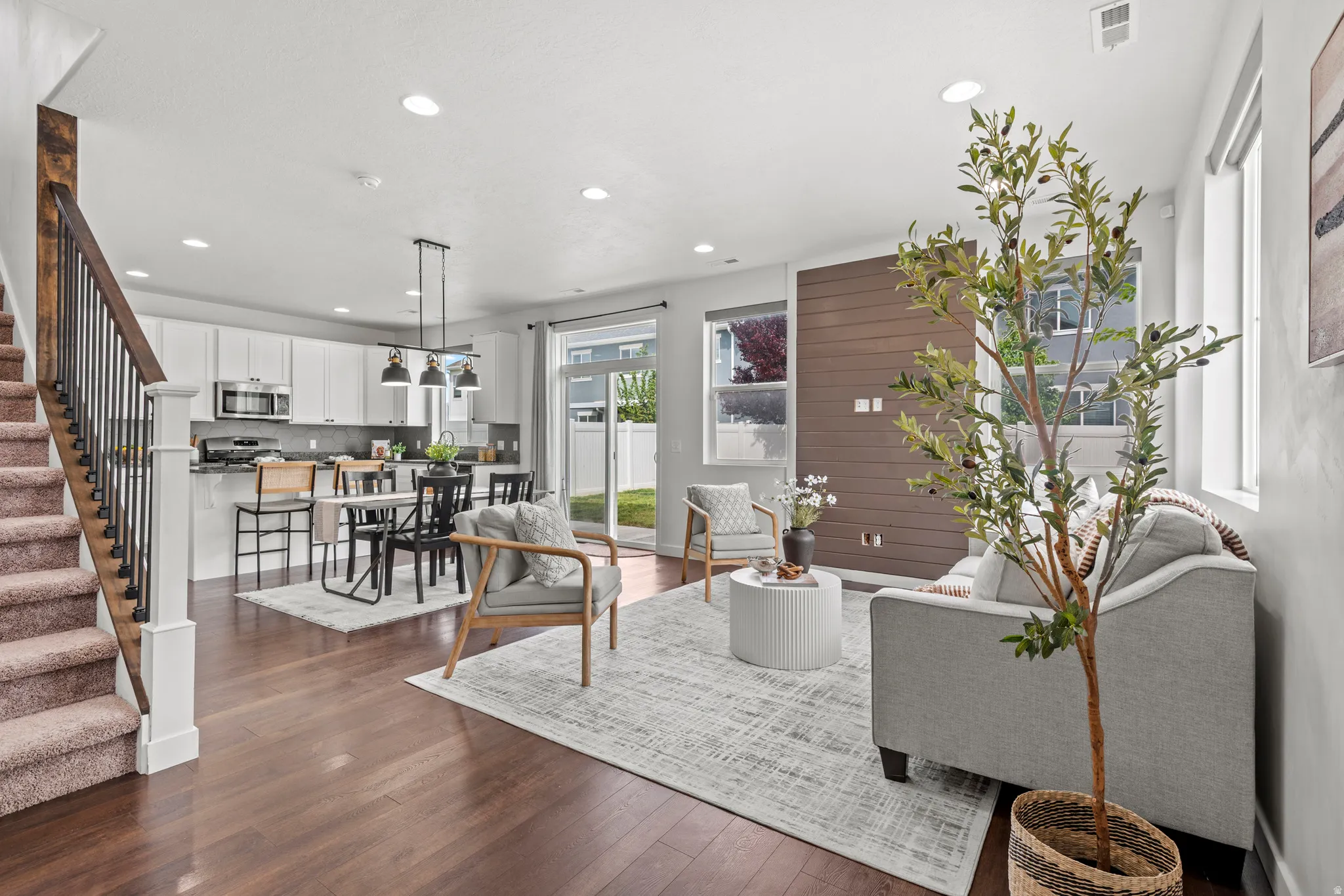 Open-concept living space with wood-finish flooring
